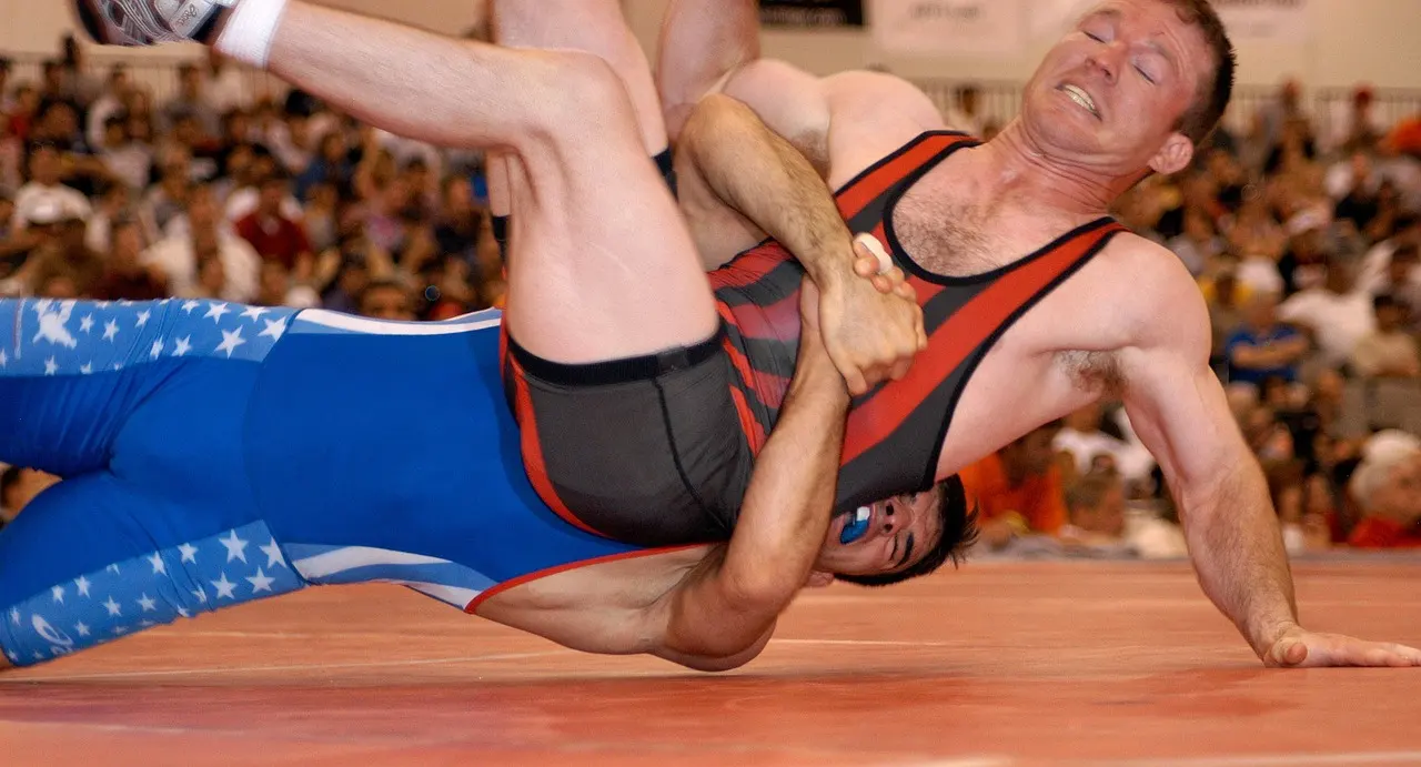 two greco roman wrestlers during a move